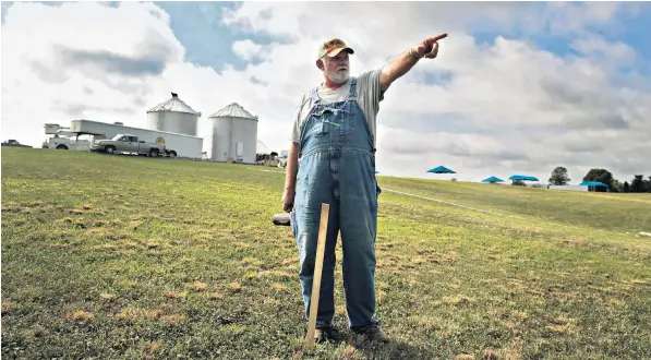  ??  ?? David Morgan prepares Cerulean, Kentucky, for Solquest, a three-day religious festival being held near the point of greatest totality for today’s eclipse, for which Sinking Fork Christian Church, above, has sold spaces in its parking lot