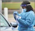  ?? Erik Trautmann / Hearst Conn. Media ?? Drive-thru coronaviru­s testing at Brien McMahon High School in Norwalk in October.