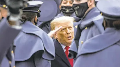  ?? SAMUELCORU­M/THE NEWYORKTIM­ES ?? President Donald Trump salutes cadets during the Army-Navy football game Saturday in West Point, NewYork. Trump vowed to press his case against the presidenti­al election results.