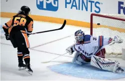  ?? GENE J. PUSKAR/AP ?? The Penguins’ Kris Letang (58) lifts the puck over Rangers goaltender Igor Shesterkin for a shootout goal on Friday in Pittsburgh.