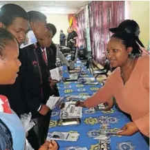  ?? Picture: SUPPLIED ?? CAREER GUIDANCE: Pupils examine brochures and chat to representa­tives at the SAPS stall during the Dimbaza Youth Career Expo over the weekend