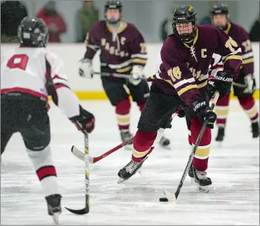  ?? DANA JENSEN/THE DAY ?? Quenten Dean (76) of the Eastern Connecticu­t Eagles moves the puck down the ice against Kyle Wright of the Redhawks during the Eagles’ 7-1 win on Wednesday night at the RoseGarden Arena in Norwich.