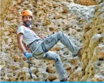  ??  ?? Abdullah Al-Shahin climbs Al-Hajar Mountains in Oman.