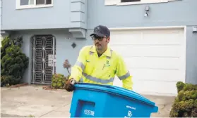  ?? Jessica Christian / The Chronicle ?? Recology collector Manuel Vera, shown on his route along 43rd Avenue in S.F., would be among the outdoor workers ensured protection from wildfire smoke.