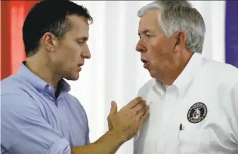  ?? Charlie Riedel / Associated Press 2017 ?? Then Missouri Gov. Eric Greitens (left) talks to Lt. Gov. Mike Parson during an Aug. 17, 2017, event at the State Fair in Sedalia. Greitens stepped down Friday amid a scandal over photos.