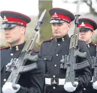  ??  ?? Members of 212 Battery RA fire the gun salute and, right, service personnel at the ceremony.