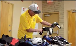  ?? NEWS FILE PHOTO ?? Lions Club of Medicine Hat member James Higgins organizes some chest protectors during their Gear Up program in 2019.