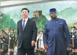  ?? WANG ZHUANGFEI / CHINA DAILY ?? President Xi Jinping walks with Sierra Leonean President Julius Maada Bio in the Great Hall of the People in Beijing on Thursday.