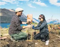  ?? PHOTO: FEDERICO PAGOLA ?? Putting down roots . . . Queenstown residents Franco Nobell, originally from Argentina, and Daniella Mercado, from Mexico, plant a tree at Jardine Park’s new Welcome Forest.