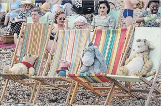  ??  ?? Winnie the Pooh, Piglet, Eeyore and Tigger relax at the beach in "Christophe­r Robin."