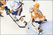  ?? FRANK GUNN — THE CANADIAN PRESS VIA AP ?? Philadelph­ia Flyers goaltender Carter Hart (79) makes a save against New York Islanders left wing Anders Lee (27) during first-period NHL Stanley Cup Eastern Conference playoff hockey game action in Toronto Saturday.