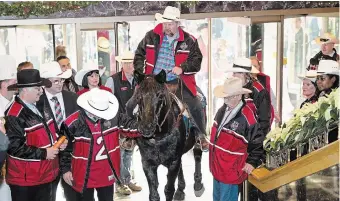  ?? PAUL CHIASSON THE CANADIAN PRESS FILE PHOTO ?? Fletcher Armstrong rides his horse, Marty, in the front entrance of the Royal York Hotel on Nov. 22, 2012, in Toronto. You can expect to see something similar in Hamilton this week.