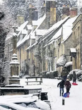  ?? Steve Parsons, Press Associatio­n ?? People sledge in the snow in Burford, Oxfordshir­e, yesterday