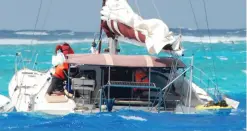  ??  ?? Damaged: The yacht sits on reef after family were saved