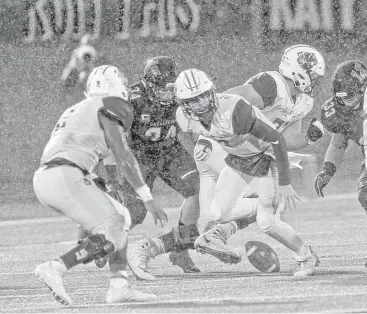  ?? Ronald Cortes ?? Katy’s Austin Marshall fumbles during the loss to Lake Travis in a Class 6A semifinals game Saturday in San Antonio. The Tigers fumbled five times, losing two.