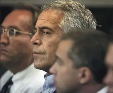  ?? THE ASSOCIATED PRESS FILE ?? Jeffrey Epstein, center, appears in court in West Palm Beach, Fla., in 2008. The wealthy financier pleaded not guilty in federal court in New York on Monday to sex traffickin­g charges after his arrest over the weekend.