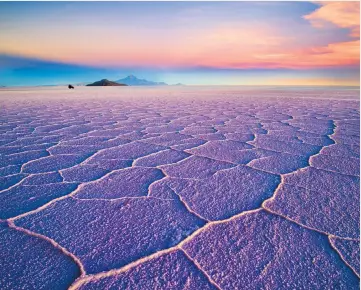  ??  ?? Sunset at the Salar de Uyuni, the salt flats of Bolivia, above; Hong Kong, where the nightlife never stops, above right