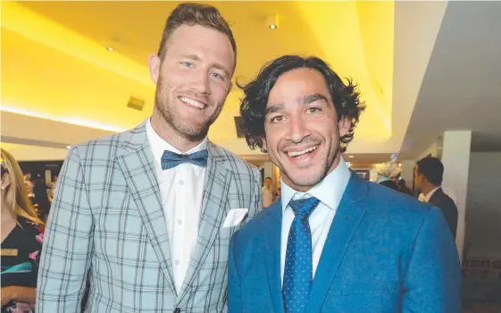  ?? Picture: MIKE BATTERHAM ?? Rugby league players Gavin Cooper and Johnathan Thurston enjoy Melbourne Cup Day at the Gold Coast Turf Club yesterday.