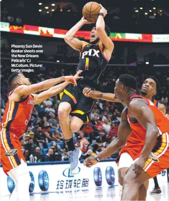  ?? Picture: Getty Images ?? Phoenix Sun Devin Booker shoots over the New Orleans Pelicans’ CJ McCollum.