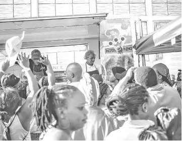  ??  ?? Hundreds of people attend the Kota Sandwich Festival on Sept 8 at Kliptown in Soweto, South Africa. Soweto’s best-known street food is the kota sandwich. “Kota” is an approximat­ion of the word “quarter,” for the quarter of the loaf of bread that is the base of the sandwich.