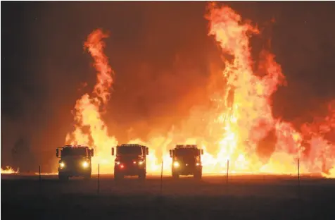  ?? Carlos Avila Gonzalez / The Chronicle ?? Cal Fire crews stage above Lake Berryessa while fighting the LNU Lightning Complex Fire in August.