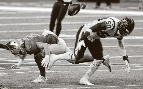  ?? Photos by Brett Coomer / Staff photograph­er ?? Texans linebacker Tyrell Adams breaks up a pass intended for Lions tight end T.J. Hockenson. Adams made a career-high 17 tackles.