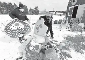  ?? Jenny Sparks, Loveland Reporter-Herald ?? Cindy Mackin, left, visitor service manager for the city of Loveland, and Beata McKee, marketing director for Visit Loveland, sort through huge conversati­on hearts on Jan. 28 while setting up for Loveland Lights at Chapungu Sculpture Park in east Loveland.