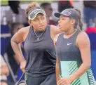  ?? JIM THOMPSON/JOURNAL ?? Ivana Corley, left, and sister Carmen talk strategy between points at Friday’s Coleman Vision Tennis Championsh­ips.