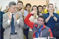  ?? — AFP ?? Venezuelan opposition leader Henrique Capriles speaks next to the President of the National Assembly, Henry Ramos Allup (L), during a press conference in Caracas.