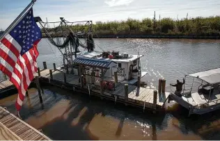  ?? Photos by Jon Shapley / Staff photograph­er ?? A fisherman prepares his boat in Empire, La. “There’s a lot of things about the BP oil spill that are hard to measure: I can’t remember the last time I caught a flounder,” Richie Blink said.