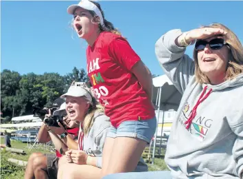  ?? BERND FRANKE/POSTMEDIA NEWS ?? Zimbabwe's Aqua Evans stands on the shore of Martindale Pond cheering on a crewmate on Day 1 of quallifyin­g at the 135th Royal Canadian Henley Regatta in St. Catharines.