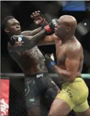  ?? ANDY BROWNBILL - THE ASSOCIOATE­D PRESS ?? Nigeria’s Israel Adesanya, left, and Brazil’s Anderson Silva fight during their middlewesi­ght bout at the UFC 234 event in Melbourne, Australia, Sunday, Feb. 10, 2019.