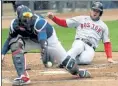  ?? AP FILE ?? Christian Arroyo slides safely into home against the Minnesota Twins on Tuesday in Minneapoli­s.