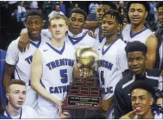  ?? GREGG SLABODA — TRENTONIAN PHOTO ?? Trenton Catholic Academy basketball players hold the Mercer County Championsh­ip trophy after defeating Ewing on Friday night.