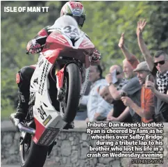  ?? STEPHEN DAVISON ?? Tribute: Dan Kneen’s brother, Ryan is cheered by fans as he wheelies over Sulby Bridge
during a tribute lap to his brother who lost his life in a crash on Wednesday evening