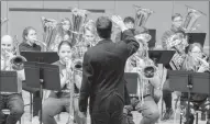  ?? Herald photo by Greg Bobinec ?? Nick Sullivan directs a group of Low Brass players made up of community members as well as high school and middle school students through a piece of music at the third annual Brass Day workshop at the University of Lethbridge, Saturday morning.