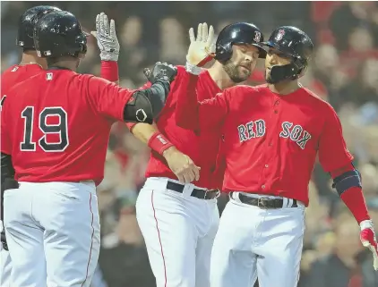  ?? STAff phoTos by mATT wesT ?? KEEPING IT TOGETHER: Eduardo Nunez (right) gets congratula­tions from Rafael Devers (back left), Jackie Bradley Jr. (19) and Mitch Moreland after his three-run home run in the first inning helped spark the Red Sox’ 7-3 victory against the Orioles last...