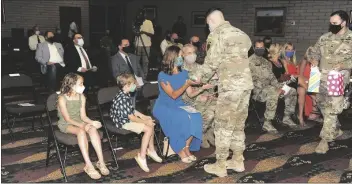  ??  ?? soldiers from the Airborne test Force presented Col. McFall’s wife Heidi with yellow roses and their two children Aisley and Liam with welcome gifts during the change of command ceremony. (photo by Mark schauer)