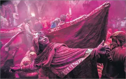  ?? Photo: Daniel Berehulak/ Getty Images ?? Gender unity: A transgende­r Hindu devotee dances during Lathmar Holi celebratio­ns (above), as Indians become more accepting of trans people after a landmark court ruling. Ardhanaris­hvara (left) is the god Shiva in an androgynou­s state with his consort,...
