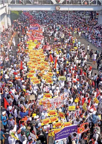  ?? — AFP photos ?? Protesters take part in a demonstrat­ion against the military coup in Yangon.