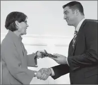  ??  ?? Rep. Clint Penzo with receives an award from Executive Director Kathy Webb.