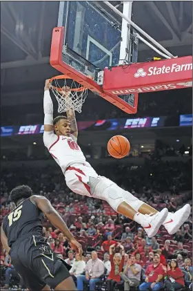  ?? Associated Press ?? Slammed: Arkansas forward Daniel Gafford (10), a former standout at El Dorado, dunks the ball over Vanderbilt defender Clevon Brown during the first half of an NCAA college basketball game Tuesday in Fayettevil­le. Arkansas plays at South Carolina today in an SEC contest.