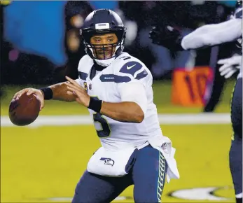  ?? CHRIS SZAGOLA — THE ASSOCIATED PRESS ?? Seahawks quarterbac­k Russell Wilson, an MVP candidate, has passed for 3,216 yards and 31 touchdowns this season.