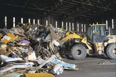  ?? Hearst Connecticu­t Media file photo ?? A large pile of garbage gets condensed by a front loader at the Stamford transfer station on Harborview Avenue in Stamford.