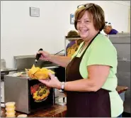  ?? HAROLD HOCH - FOR MEDIANEWS GROUP ?? french fries, she said, while many people also like to take home fresh hoagies for their lunch the next day. Michele Greer of Schwenksvi­lle manages the soft pretzels and nachos stand at the Oley Fair.