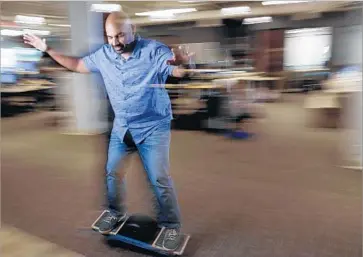  ?? Howard Lipin San Diego Union-Tribune ?? NAVEEN RAO, founder of Nervana, a player in the artificial-intelligen­ce realm, rides an electric skateboard around his office in San Diego. Rao’s job is to help Intel move beyond the central processing unit, or CPU.