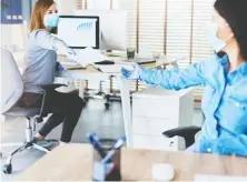  ?? GETTY IMAGES ?? As workers slowly return to their offices, employers are faced with the challenge of keeping them six feet apart.