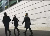  ?? Seth Wenig / Associated Press ?? Pedestrian­s walk past the front of Goldman Sachs headquarte­rs in New York.