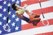  ?? CHARLIE RIEDEL/ASSOCIATED PRESS ?? Samuel Mikulak spins in the air during his still rings routine Saturday night en route to a sixth USA Gymnastics all-around title.