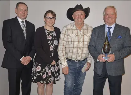  ?? SCOTT ANDERSON/SOUTHWEST BOOSTER ?? Larry Johnson was singled out as the Citizen of the Year at the SCBEX Spirit of Swift Current Awards. Chamber Board Chairman Doug Evjen was assisted by category sponsors Kara Thompson from Community Futures Southwest and Lawrence Carr from Whisky Jack Creek Constructi­on in presenting Johnson with his award.